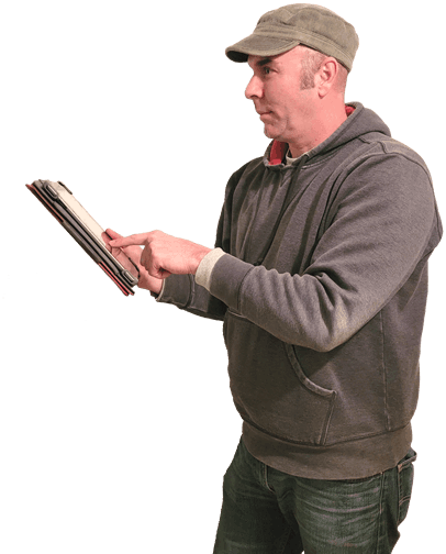 Chris MacKenzie from MacKenzie Home holding a tablet